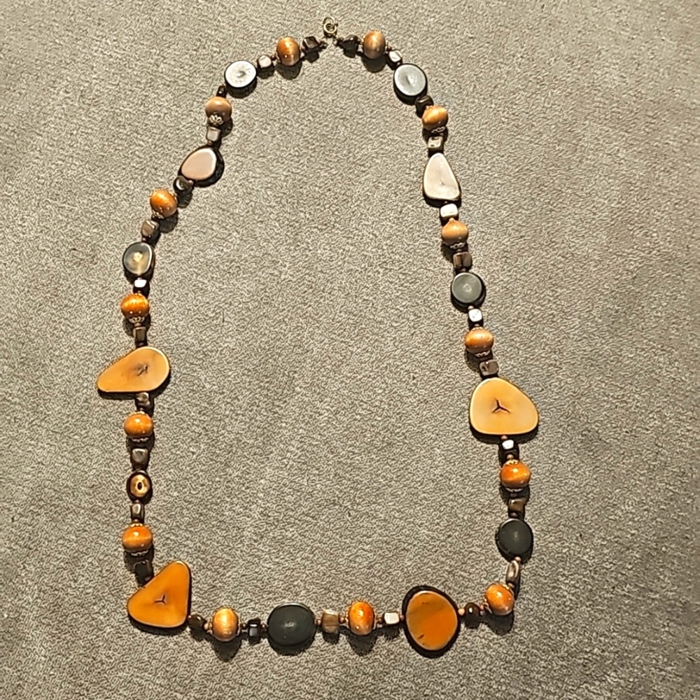 Long costume necklace with wood colored plastic beads